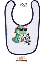 Baby-Lätzchen SOL’S Babib in Weiß / Marineblau mit Motiv Cool since Birth – Dino