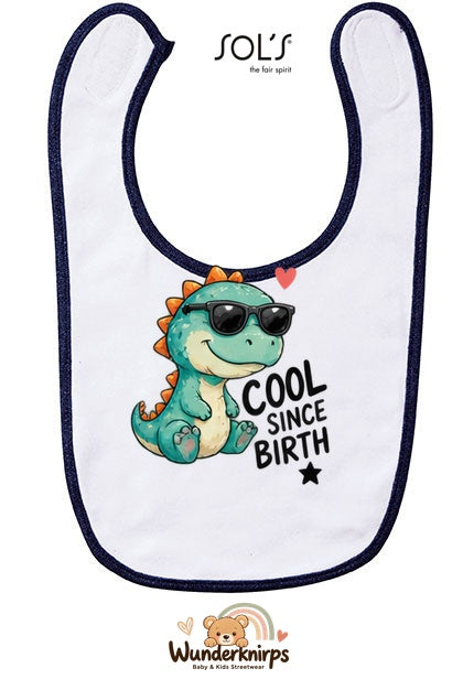 Baby-Lätzchen SOL’S Babib in Weiß / Marineblau mit Motiv Cool since Birth – Dino