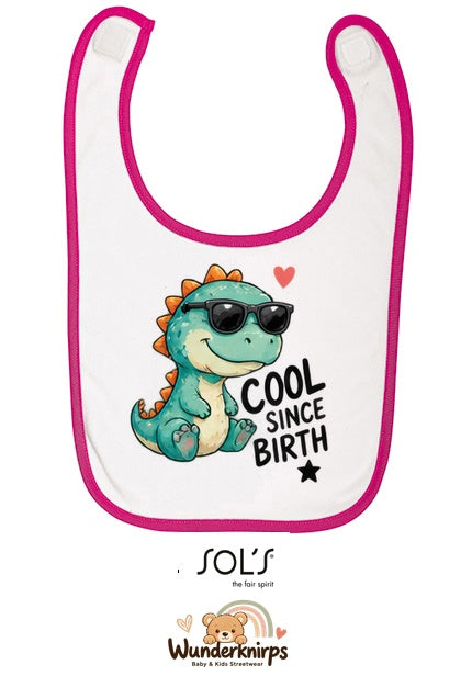 Baby-Lätzchen SOL’S Babib in Weiß / Fuchsia mit Motiv Cool since Birth – Dino