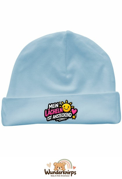 Umschlagmütze Rox-01 in Pastellblau mit Motiv Mein Lächeln ist ansteckend