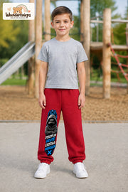 Junge trägt rote Jogginghose mit Disziplin heute Hoodie-Print, von vorn auf dem Spielplatz.