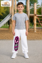 Junge trägt weiße Jogginghose mit Kleine Dinge Schmetterling-Print, von vorn auf dem Spielplatz.