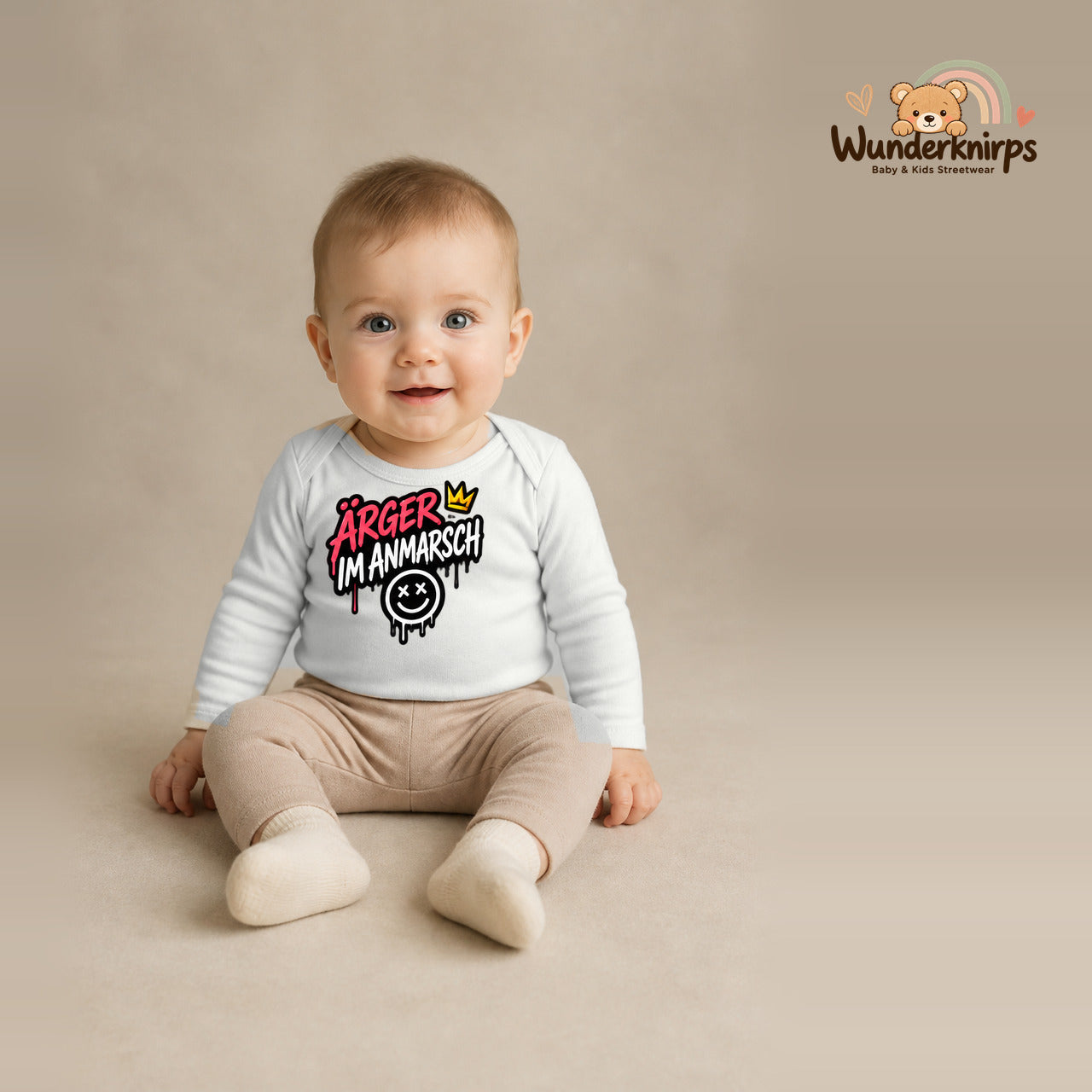 Babybody für Jungen in Weiß mit Motiv „Ärger im Anmarsch“, getragen von einem Kind – Wunderknirps.