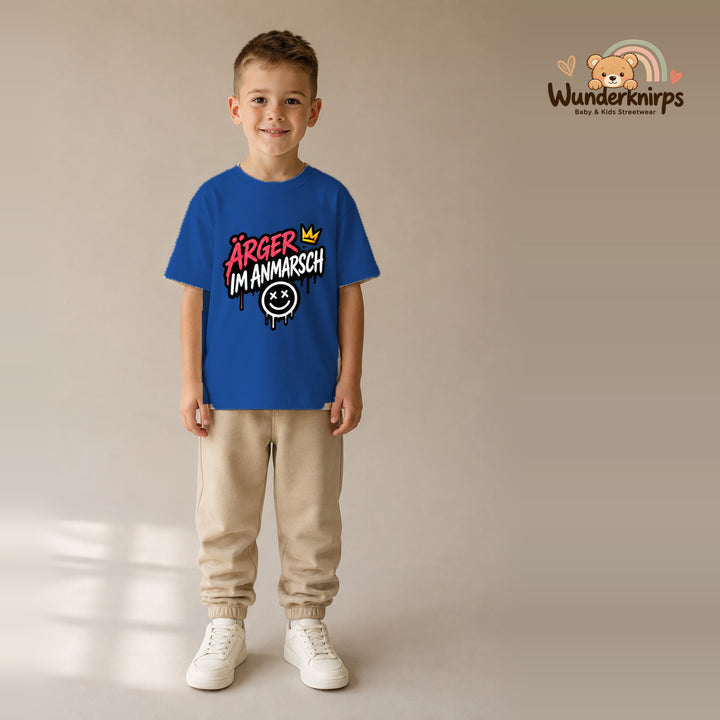 T-Shirt für Jungen in Blau mit Motiv „Ärger im Anmarsch“, getragen von einem Kind – Wunderknirps.