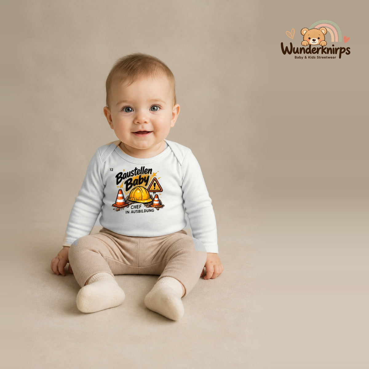 Babybody für Jungen in Weiß mit Motiv „Baustellenbaby“, getragen von einem Kind – Wunderknirps.