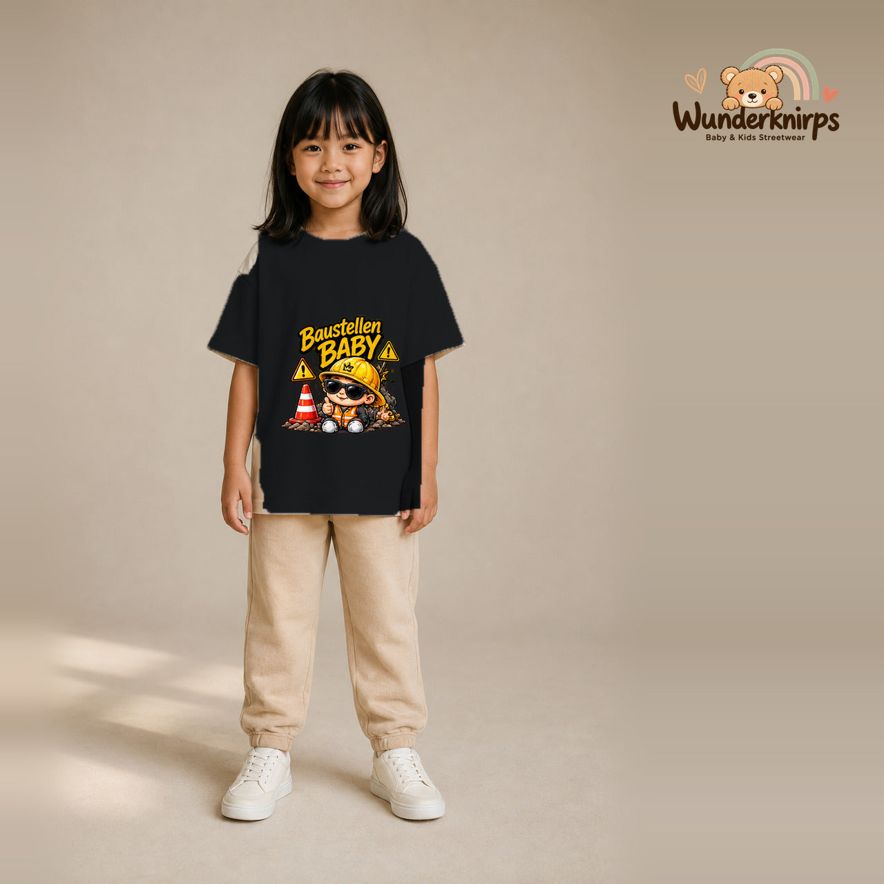 T-Shirt für Mädchen in Schwarz mit Motiv „Baustellenbaby“, getragen von einem Kind – Wunderknirps.