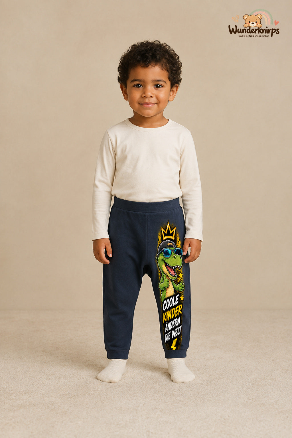 Coole kinder ändern die welt – Babyhose mit dem Motiv Dino – für Jungen: Navy mit Dino-Druck am Hosenbein – Wunderknirps.
