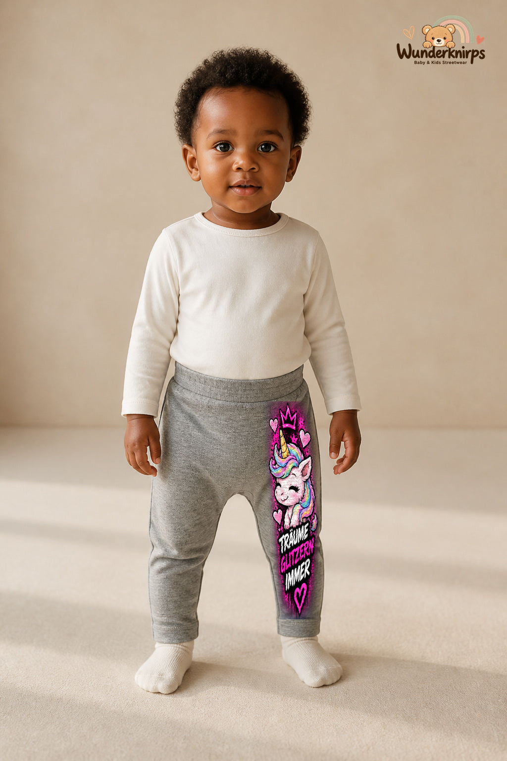 Einhorn Traumlook – Träume glitzern immer – Babyhose für Mädchen: Grau meliert mit Einhorn-Druck am Hosenbein – Wunderknirps.