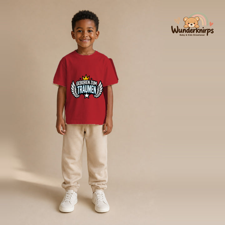 T-Shirt für Jungen in Rot mit Motiv „Geboren zum Träumen“, getragen von einem Kind – Wunderknirps.