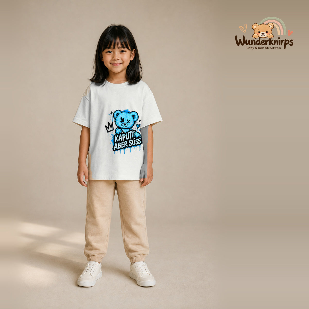 T-Shirt für Mädchen in Weiß mit Motiv „Kaputt aber süß“, getragen von einem Kind – Wunderknirps.