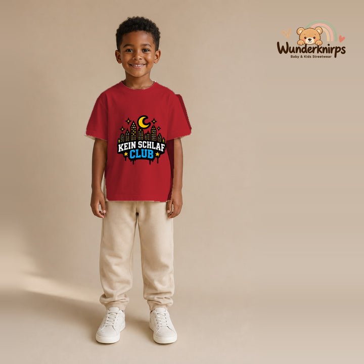 T-Shirt für Jungen in Rot mit Motiv „Kein Schlaf Club“, getragen von einem Kind – Wunderknirps.