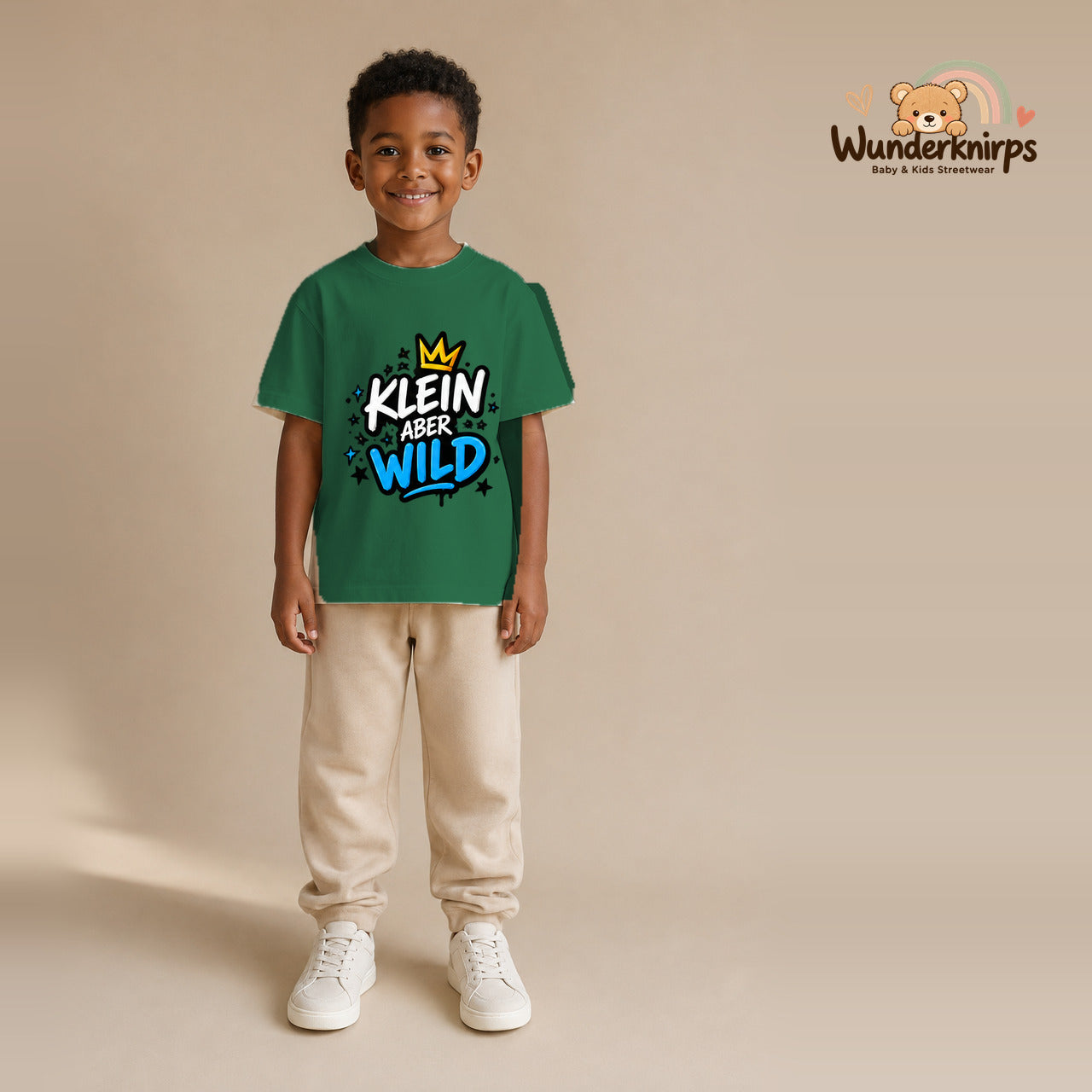 T-Shirt für Jungen in Grün mit Motiv „Klein aber wild“, getragen von einem Kind – Wunderknirps.
