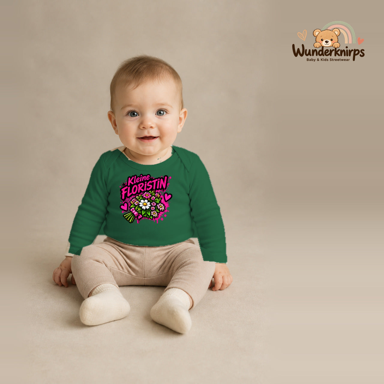 Babybody für Jungen in Grün mit Motiv „Kleine Floristin“, getragen von einem Kind – Wunderknirps.