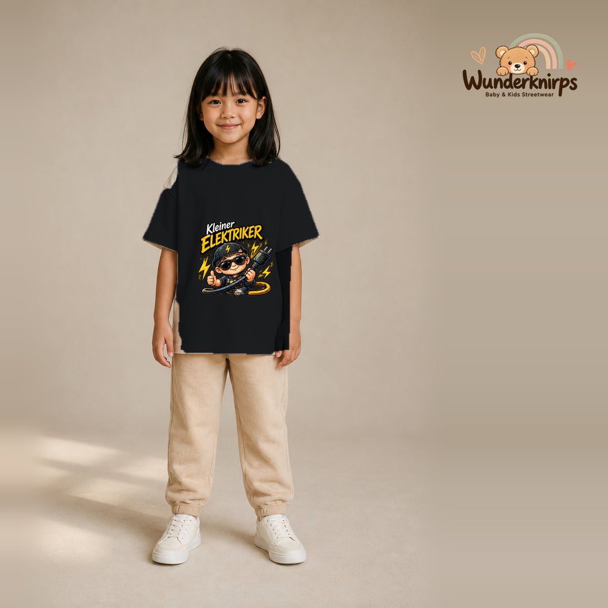 T-Shirt für Mädchen in Schwarz mit Motiv „Kleiner Elektriker“, getragen von einem Kind – Wunderknirps.