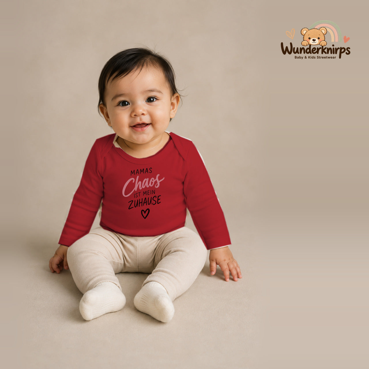 Babybody für Mädchen in Rot mit Motiv „Mamas Chaos“, getragen von einem Kind – Wunderknirps.