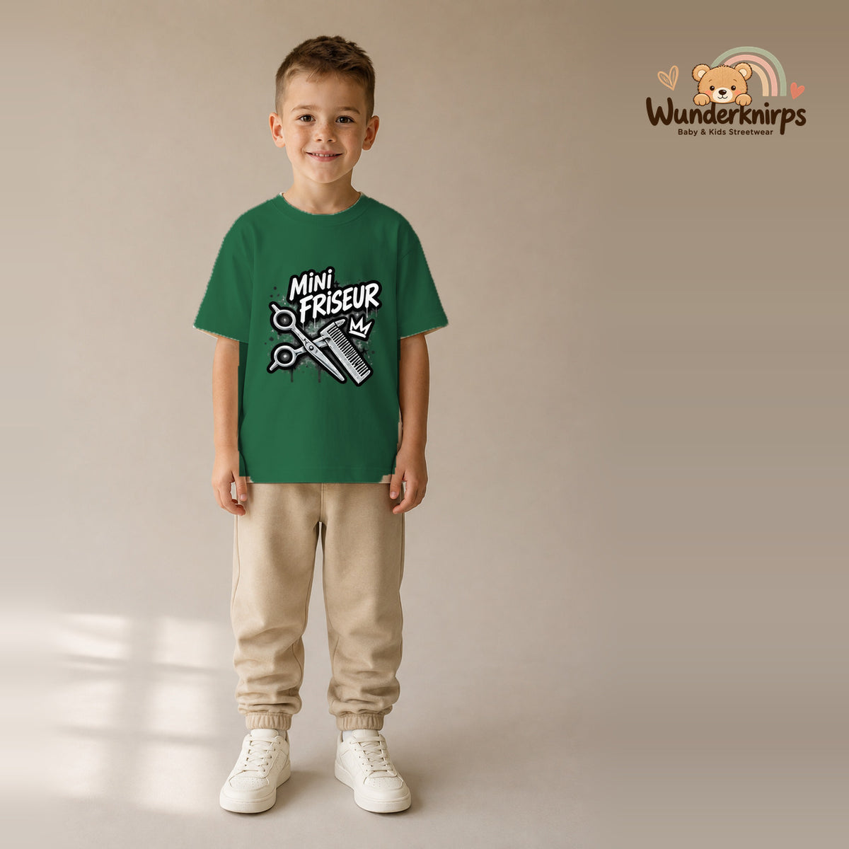 T-Shirt für Jungen in Grün mit Motiv „Mini Friseur“, getragen von einem Kind – Wunderknirps.