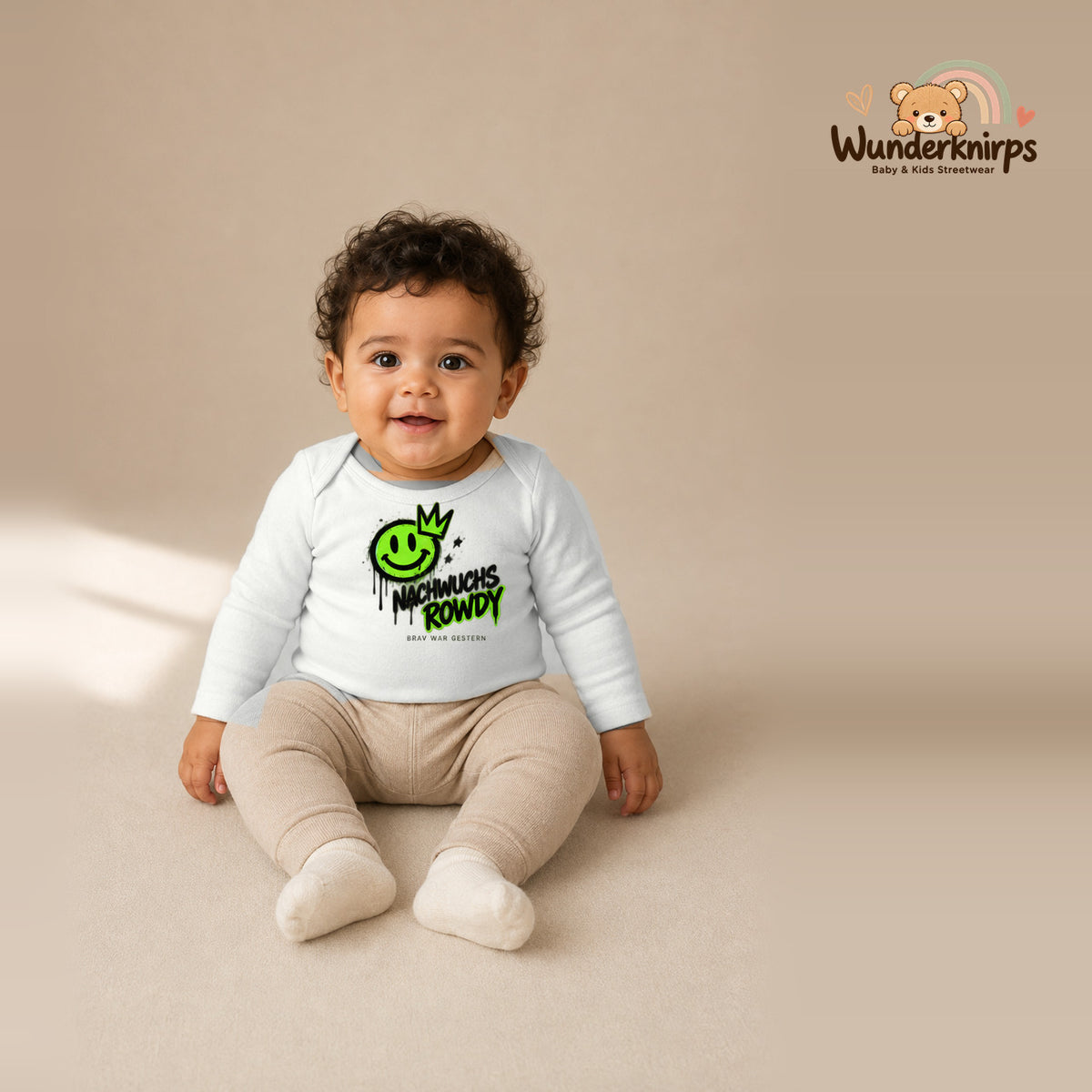 Babybody für Jungen in Weiß mit Motiv „Nachwuchs Rowdy“, getragen von einem Kind – Wunderknirps.