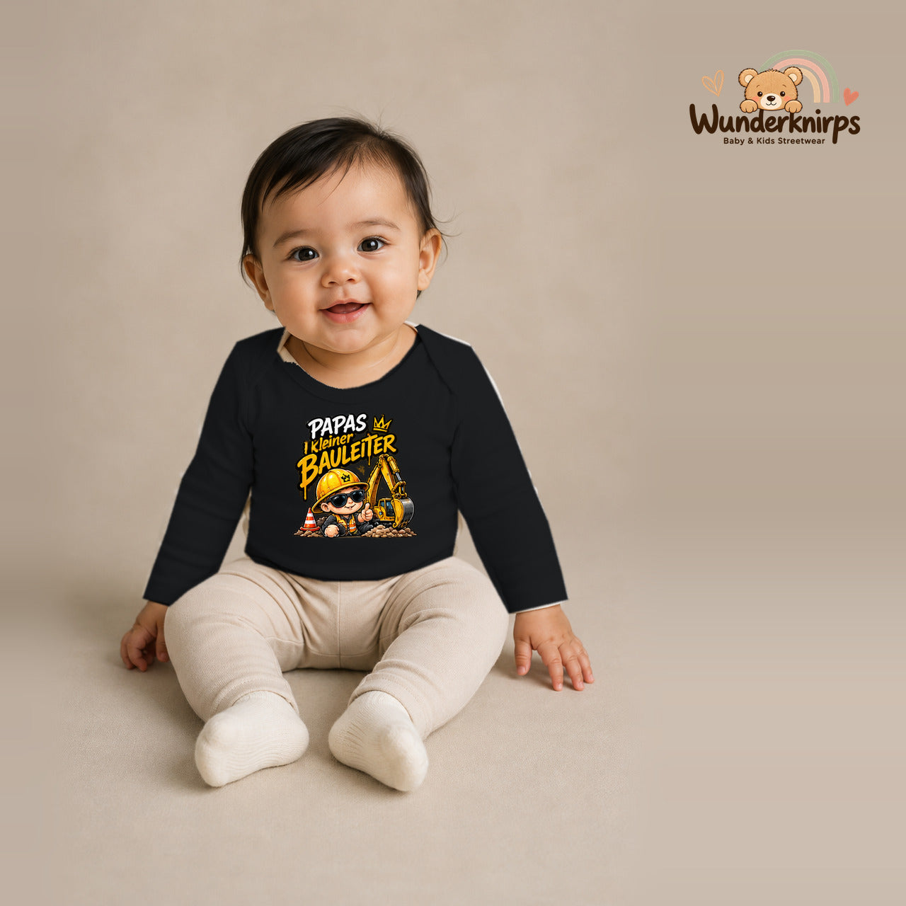 Babybody für Mädchen in Schwarz mit Motiv „Papas kleiner Bauleiter“, getragen von einem Kind – Wunderknirps.