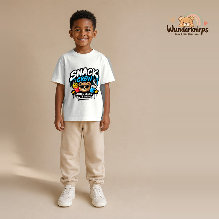 T-Shirt für Jungen in Weiß mit Motiv „Snack Crew“, getragen von einem Kind – Wunderknirps.