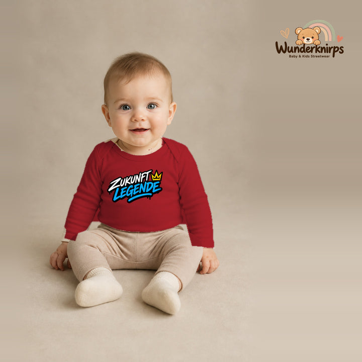 Babybody für Jungen in Rot mit Motiv „Zukunft Legende“, getragen von einem Kind – Wunderknirps.